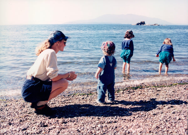 mom with 3 daughters on rocky PNW beach