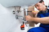 plumber-fixing-sink