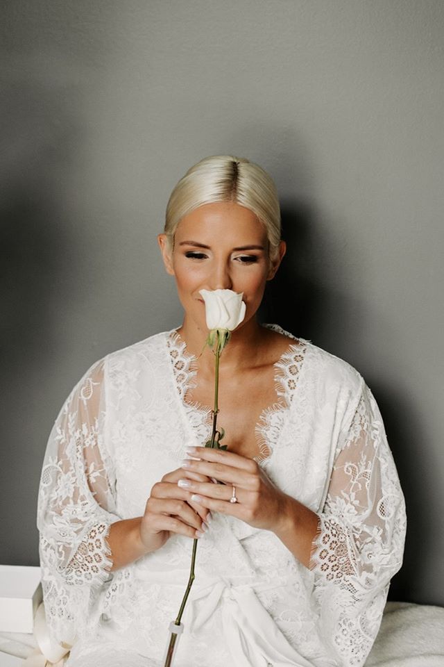 a bride on her wedding day in the Lara Lace lace bridal robe in white from By Catalfo