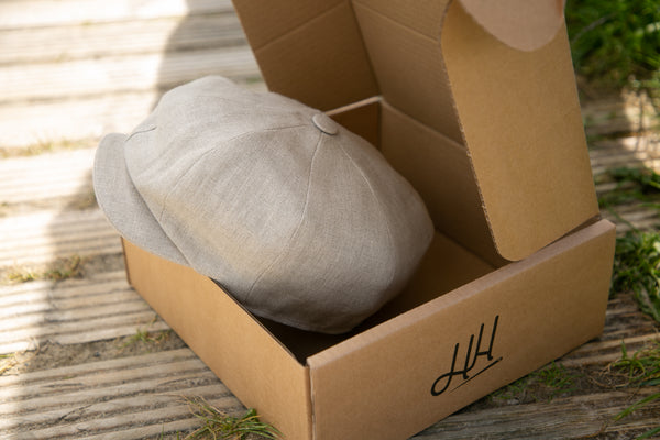 Cap in a box sitting on a boardwalk