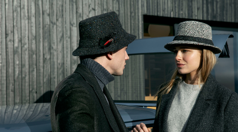 Man and woman wearing tweed hats