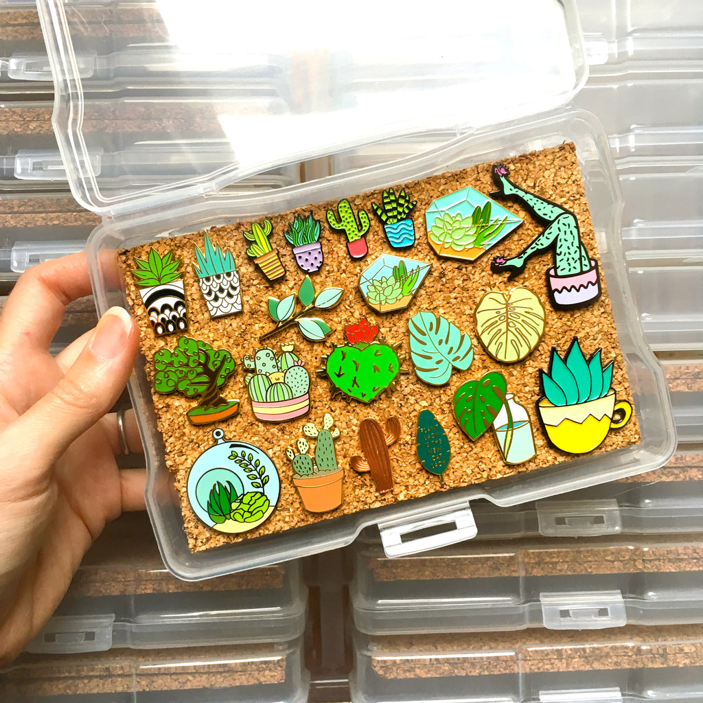 cork board with pins in a plastic container