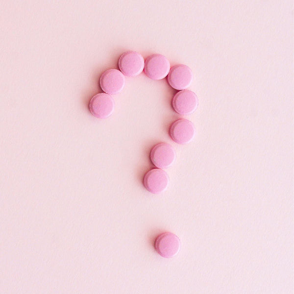 pink pills are shaped in a question mark