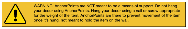 Warning label for AnchorPoints™ saying they are not to be used to hang picture frames, only to be used on the bottom corners to keep the frames from moving once they are hung.