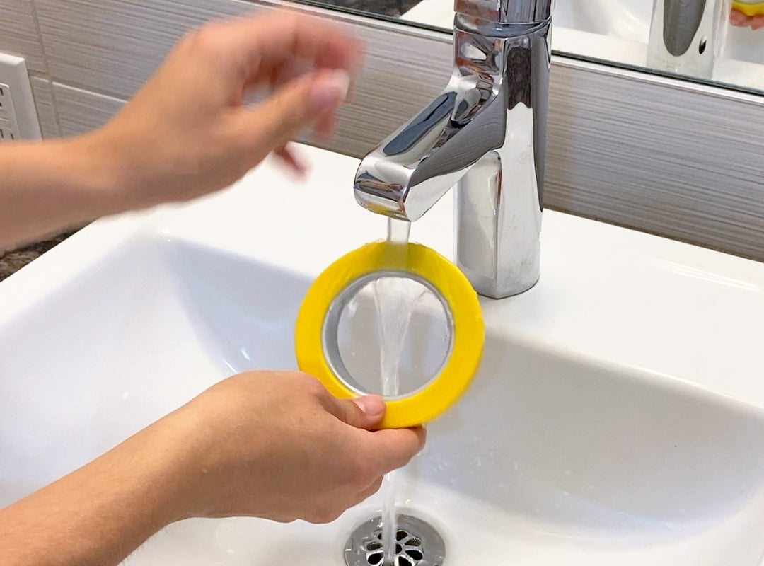 Image of a person washing Doree™ under the tap to remove dirt so that it restores it's grip