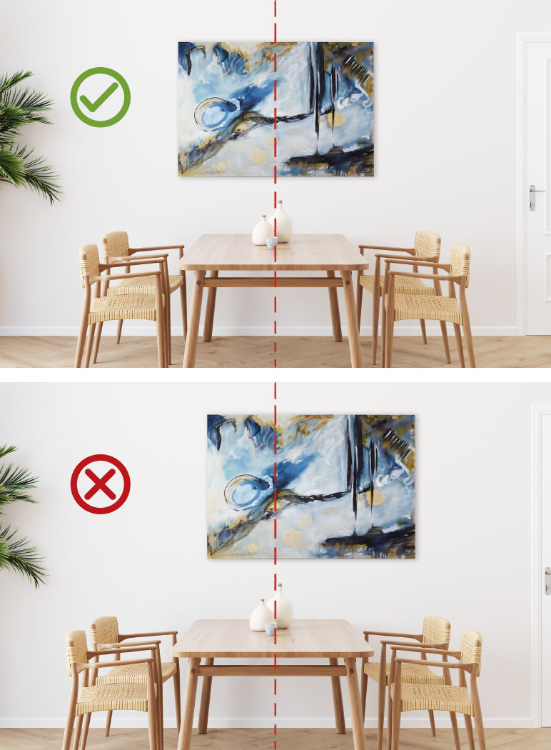 Two images of artwork hung above a table: one centered with the table and one centered with the wall. There is a check mark on the one centered with the table to indicate this is the correct way to hang the art.