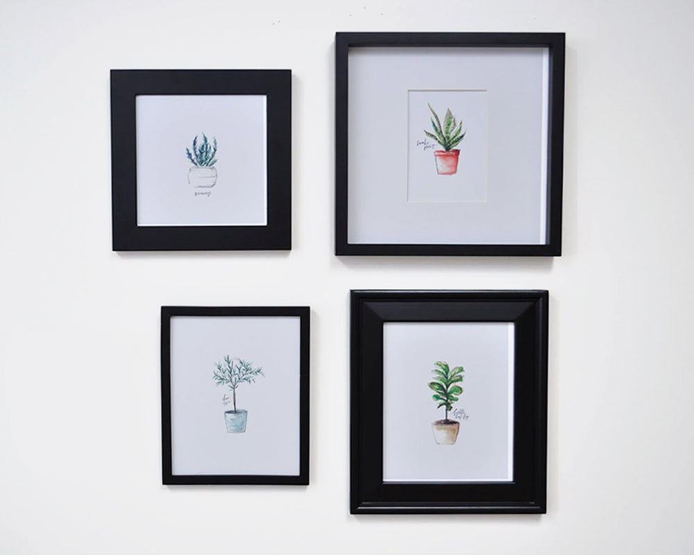 Four different pictures in black frames with different thicknesses to demonstrate the idea of visual weight to create visual balance in a gallery wall.