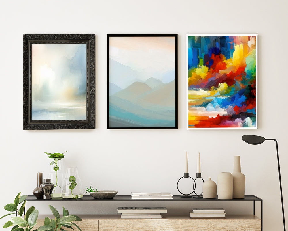 A gallery of 3 pictures hanging above a side table with three different colored images and 3 different frames to show the idea of visual weight to create visual balance in a gallery.