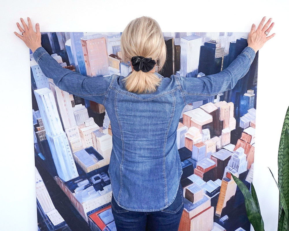 Image showing a person hanging a large canvas art on their own using Place&Push™ CanvasHangers™