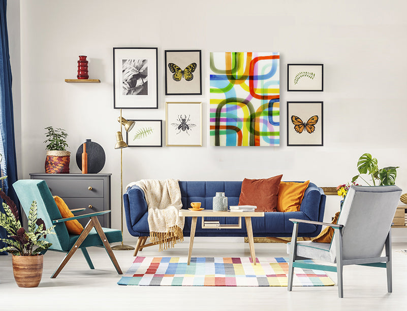 A gallery wall of 7 pieces using a large abstract art piece to anchor the gallery collection.