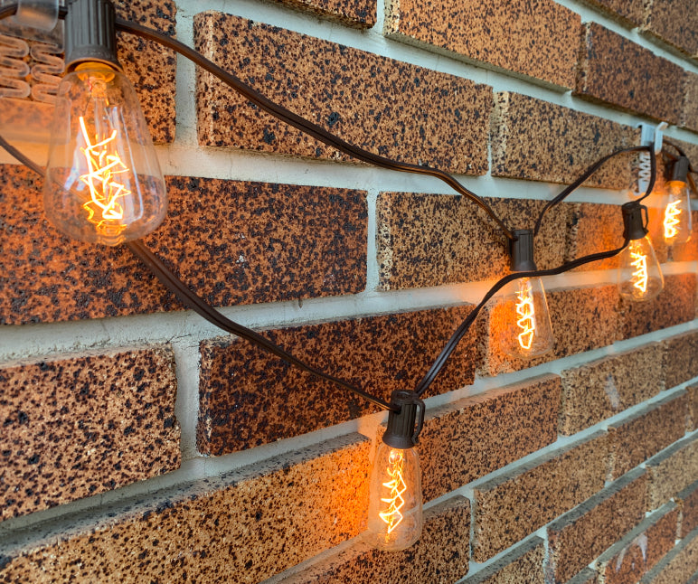 Outdoor lights easily hung using DécoBrick™ hangers to decorate an outdoor space