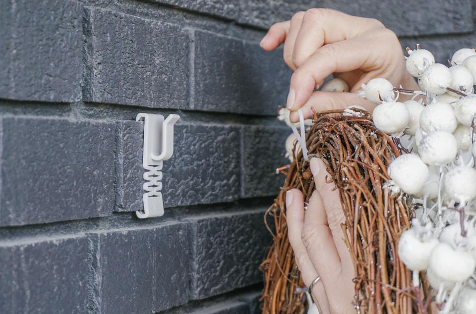 Using a zip tie to hang a wreath on brick