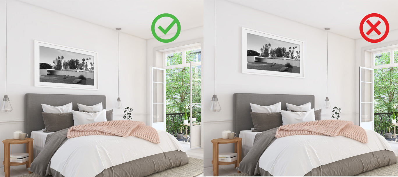 The same image of art hung above a bed - one is at the right height and the other is too high.