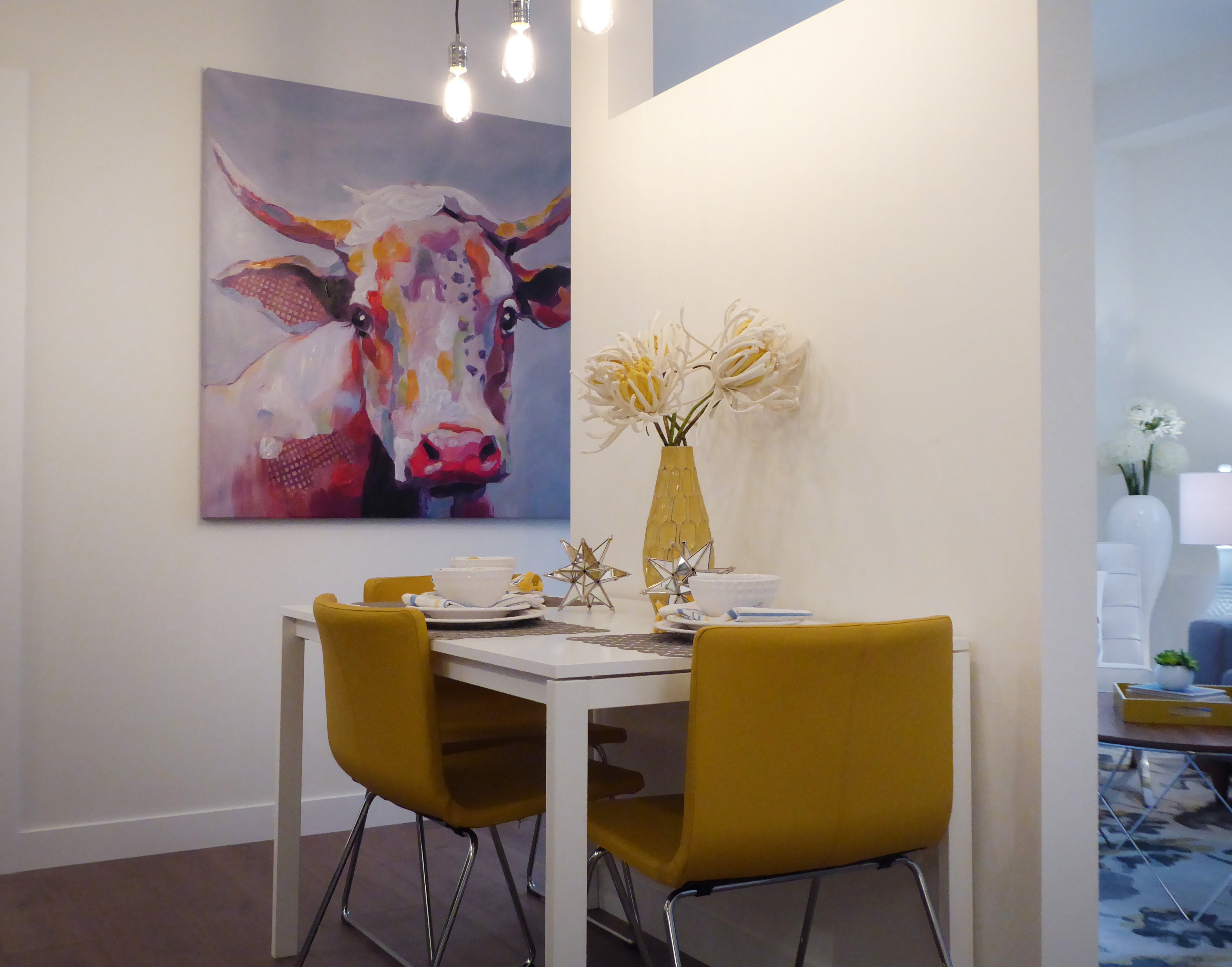 image of a cow canvas hung in a dinning room