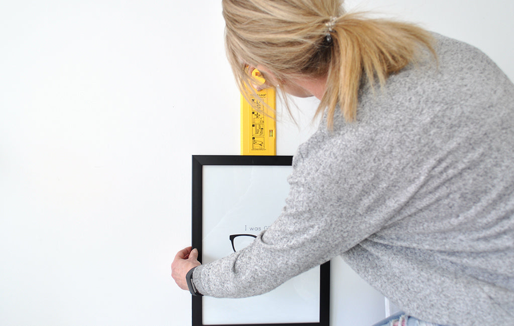 Hanging a picture frame with Hang&Level picture hanging tool