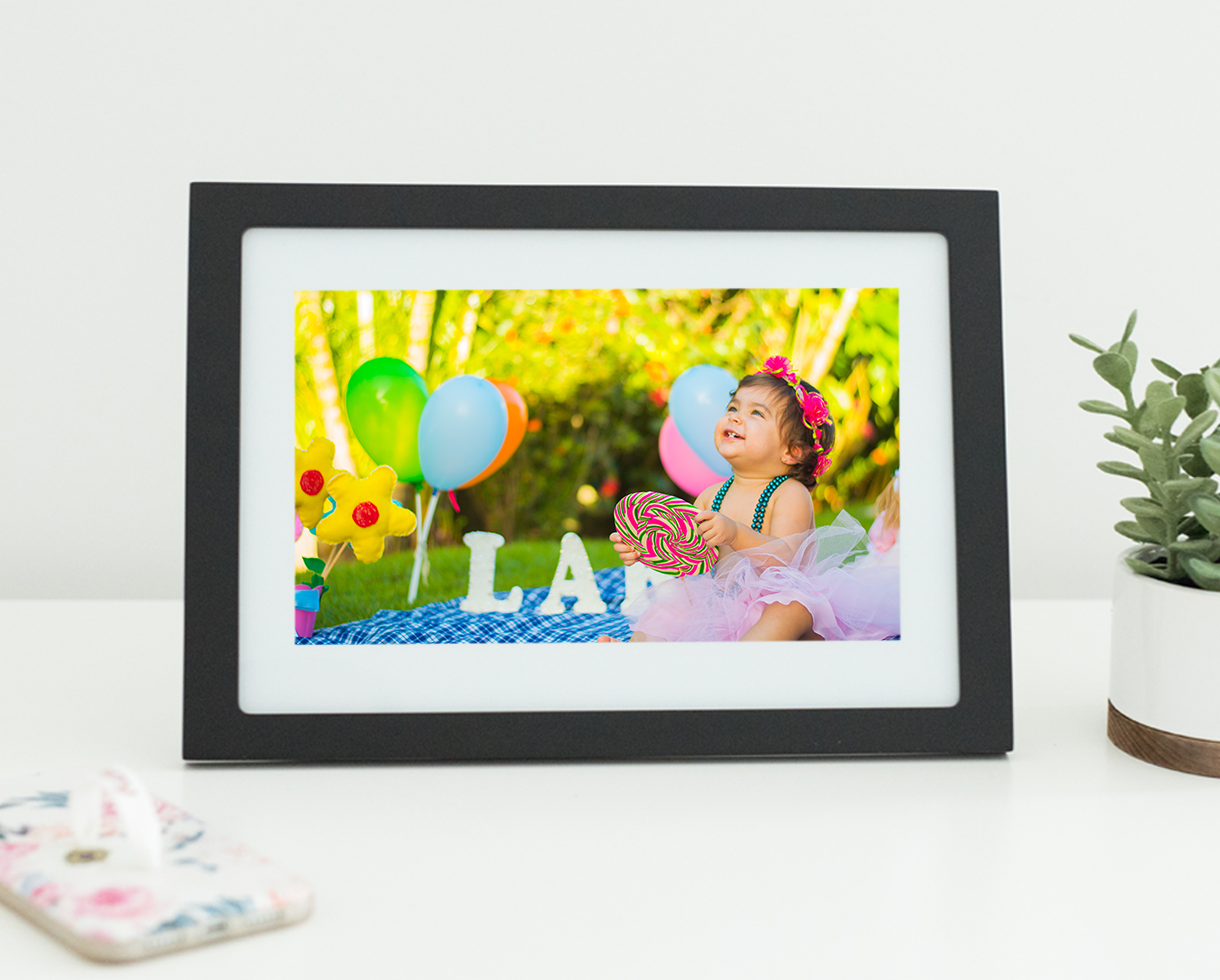 Celebrating a birthday party outside displayed in a Skylight Frame