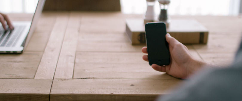 Person smartphone hand table