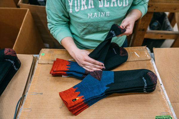 Darn tough mill worker folding our merino wool socks