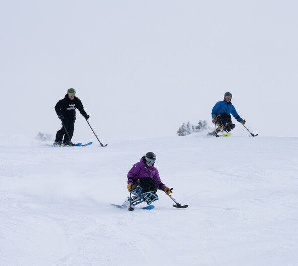 Three High Five skiers coming down the slope