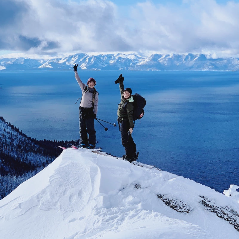 Michelle and a friend celebrating reaching the summit of a mountain