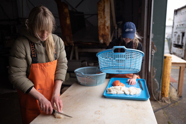 Claire and Emma cutting up salmon