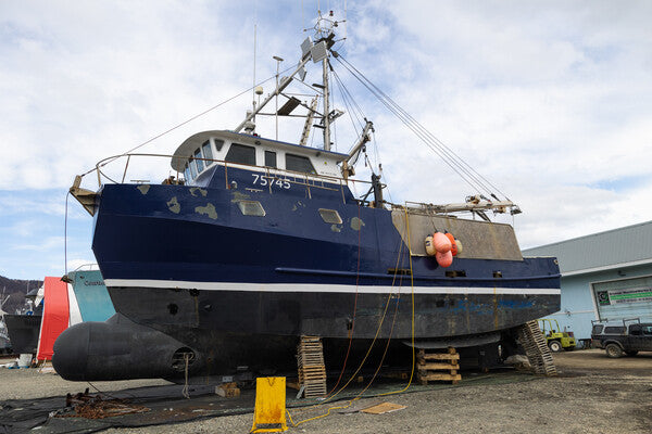 The Stanley K boat, currently in dry dock, a blue fishing vessel