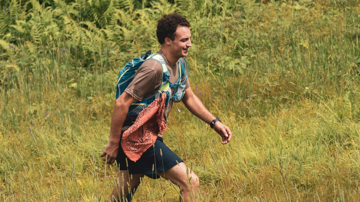 Ultrarunner Ben Feinson going through a field on the Long Trail