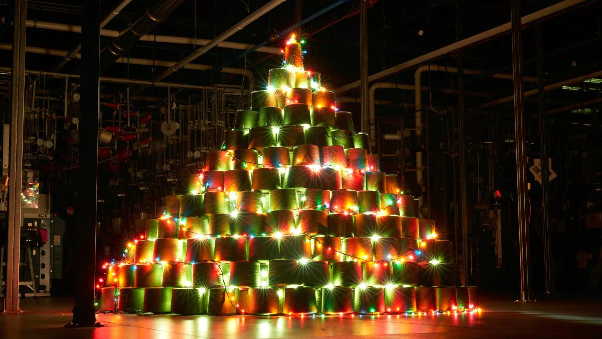 A Christmas tree made of merino wool yarn cones, set up in the Darn Tough mill