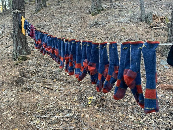 Laundry line of darn tough merino wool hiking socks hanging to dry