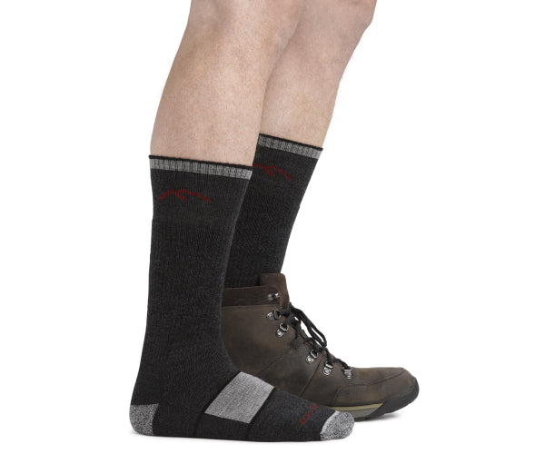 Pair of feet wearing darn tough boot socks, the perfect height for hiking boots