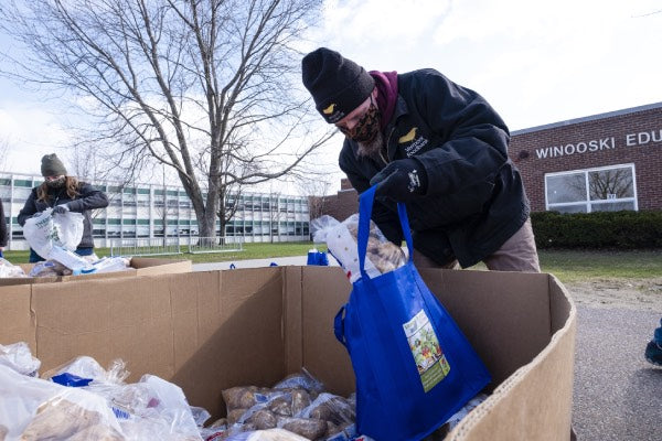 Man filling a bag with potatoes