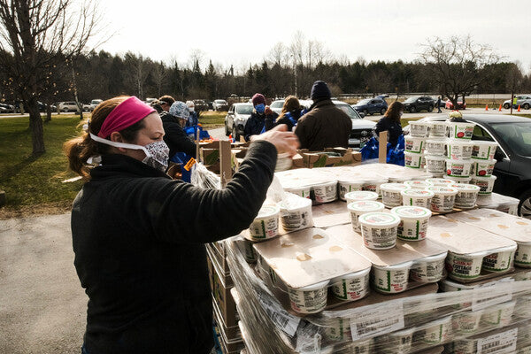 Volunteer with stacks of food to feed the hungry