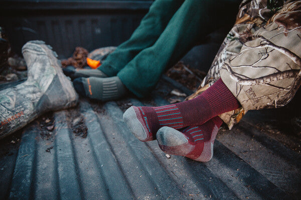 Feet in truck bed wearing darn tough hunting socks, men's and women's