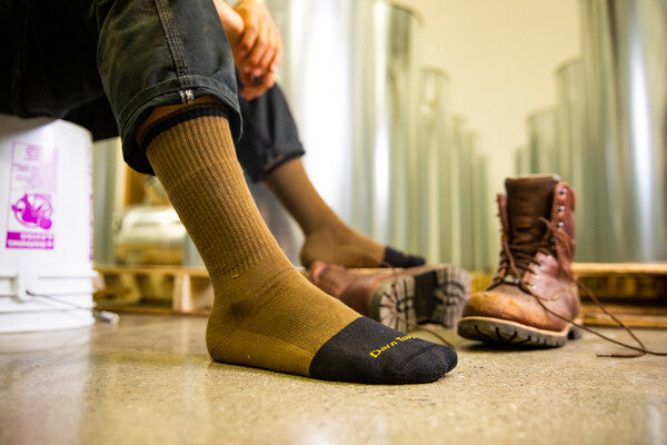 Close up of construction worker wearing merino wool socks and boots