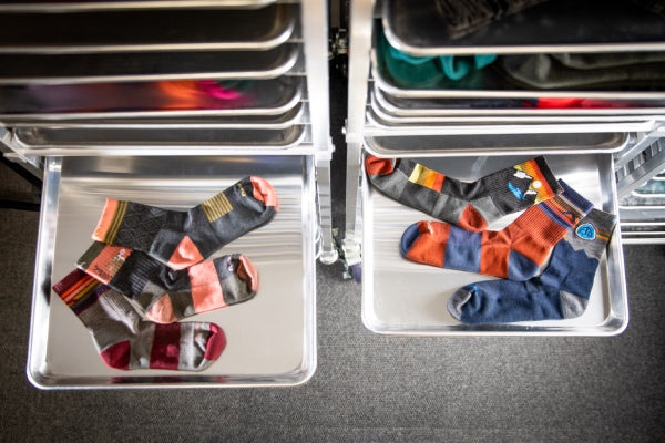 A bunch of new socks on sheet pans, ready to be examined