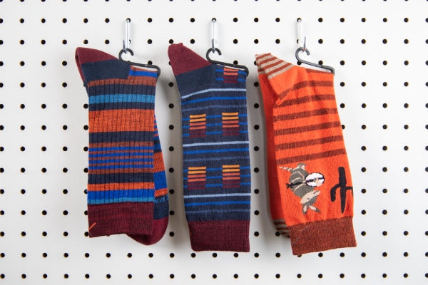 Three socks hanging on a wall next to each other