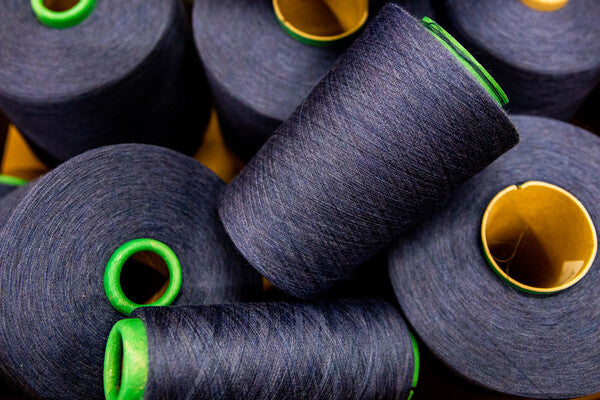 Cones of Merino Wool yarn in dark blue