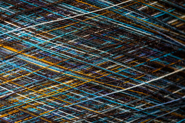 Closeup of dyed merino wool yarn in blues and yellows