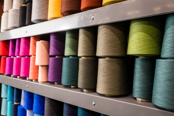 Shelves full of Merino Wool yarn cones