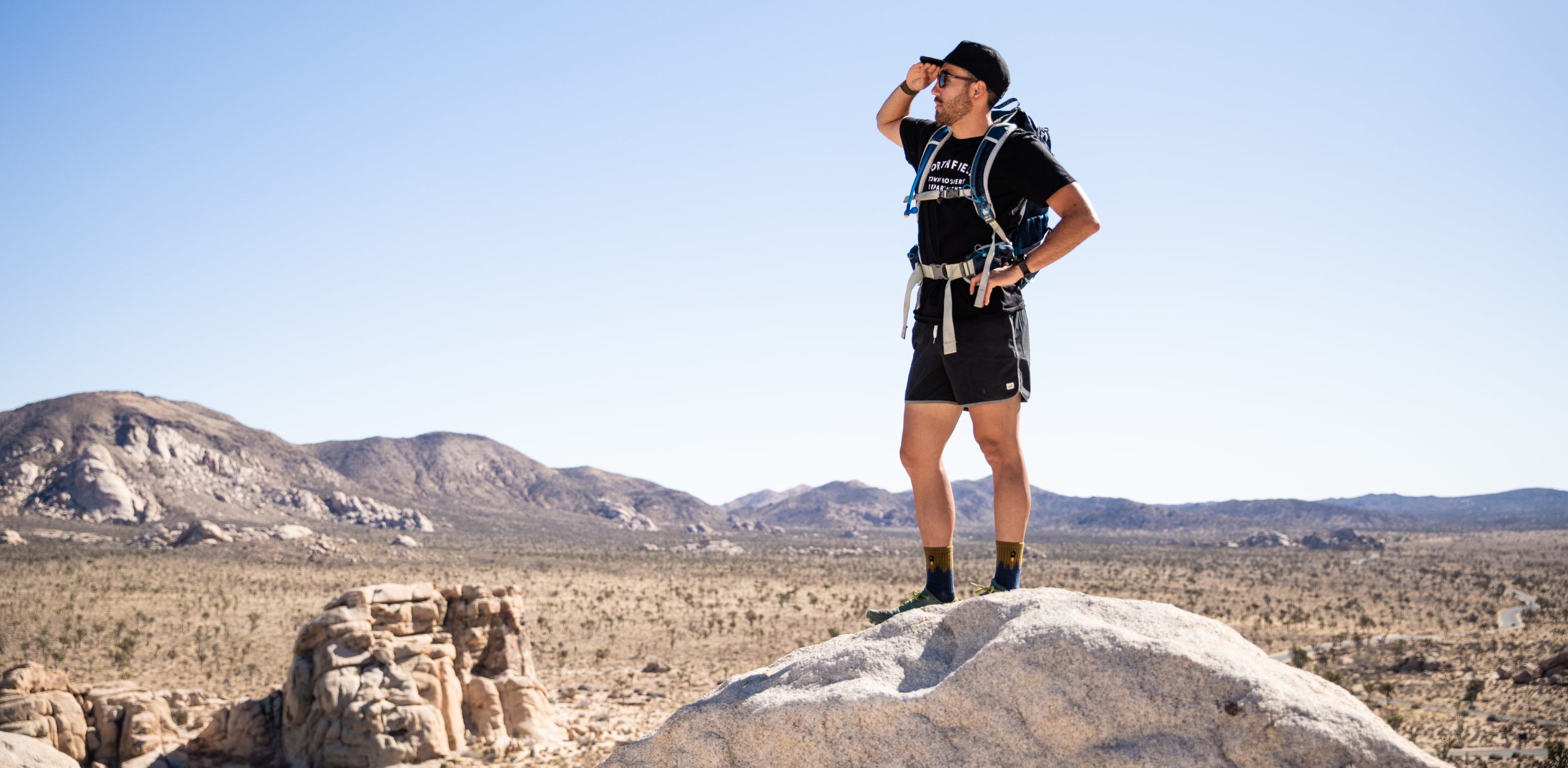 A hiker looking off into the distance for answers to sock questions