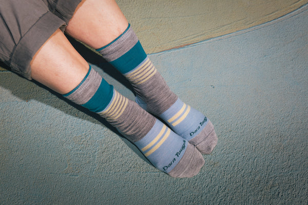 A person wearing two darn tough socks