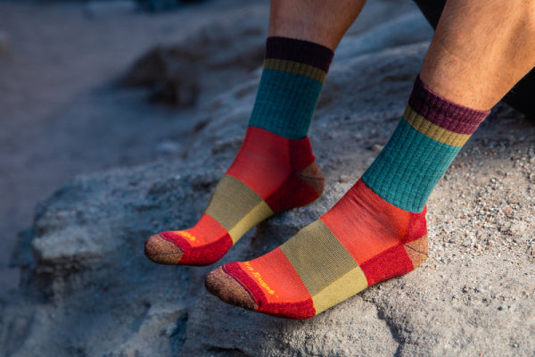 Pair of feet wearing the lightweight Heady Strip hiking socks