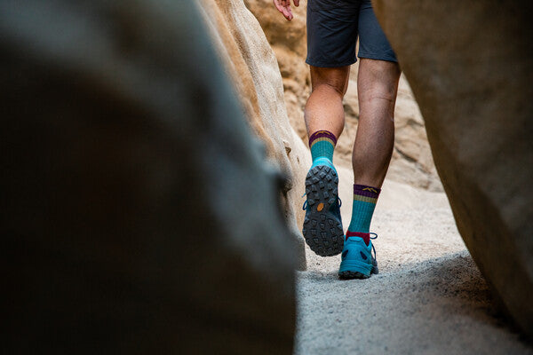 Feet wearing performance fit hiking socks and shoes