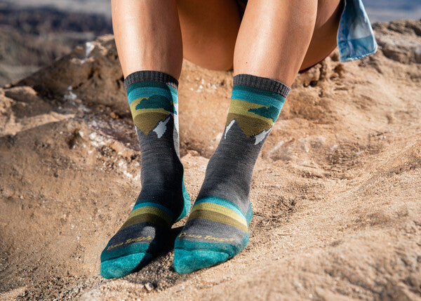 Closeup of feet wearing the Sunset Ledge with it's mountain sunset design