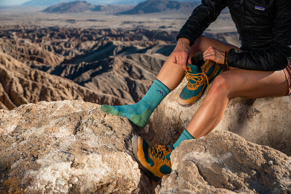Hiker wearing the women's hiker micro crew socks in bright blue