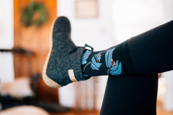 Closeup of foot wearing Lillies socks with a lily flower pattern