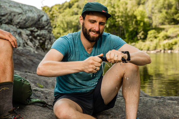 Hiker wringing excess moisture out of his hiking socks
