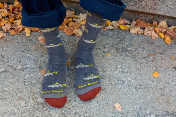 Feet wearing the Spey Fly casual and dress lifestyle socks with fish on them