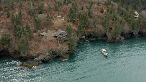 An aerial view of a remote home on the coast