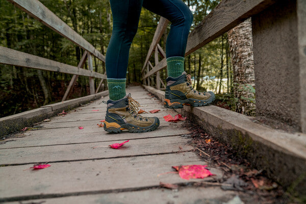 Feet on bridge wearing the Women's Hiker Micro Crew socks in blue